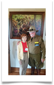 Jeffrey L. Maahs and Raqui in front of the painting of the Last Cavalry Charge in the Museum
